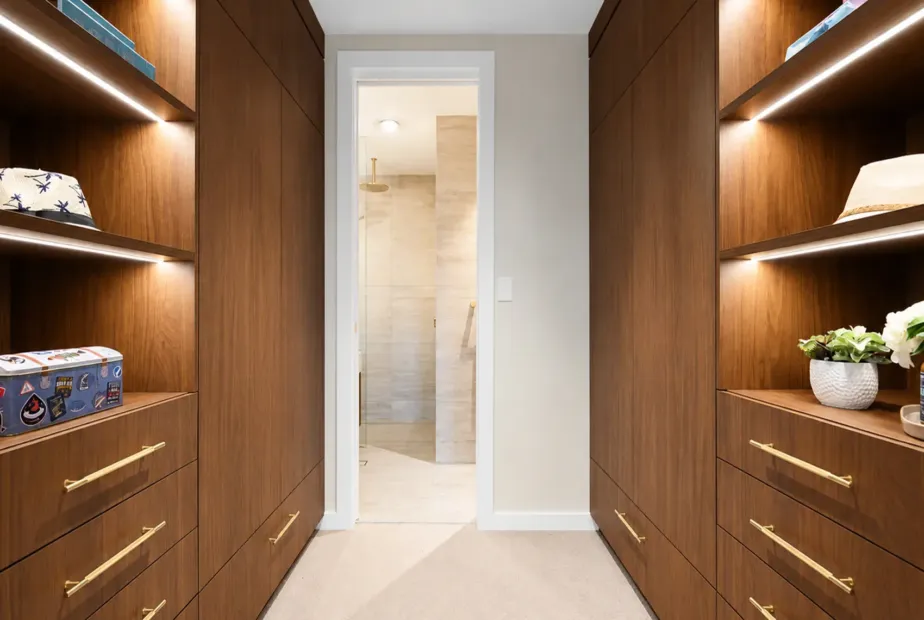 Floor-to-ceiling built-in wardrobe in a Melbourne bedroom with custom hanging space, drawers, shelving and fitted storage.