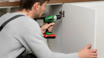 Melbourne homeowner reviewing custom kitchen cabinet drawings and material samples with a cabinet maker