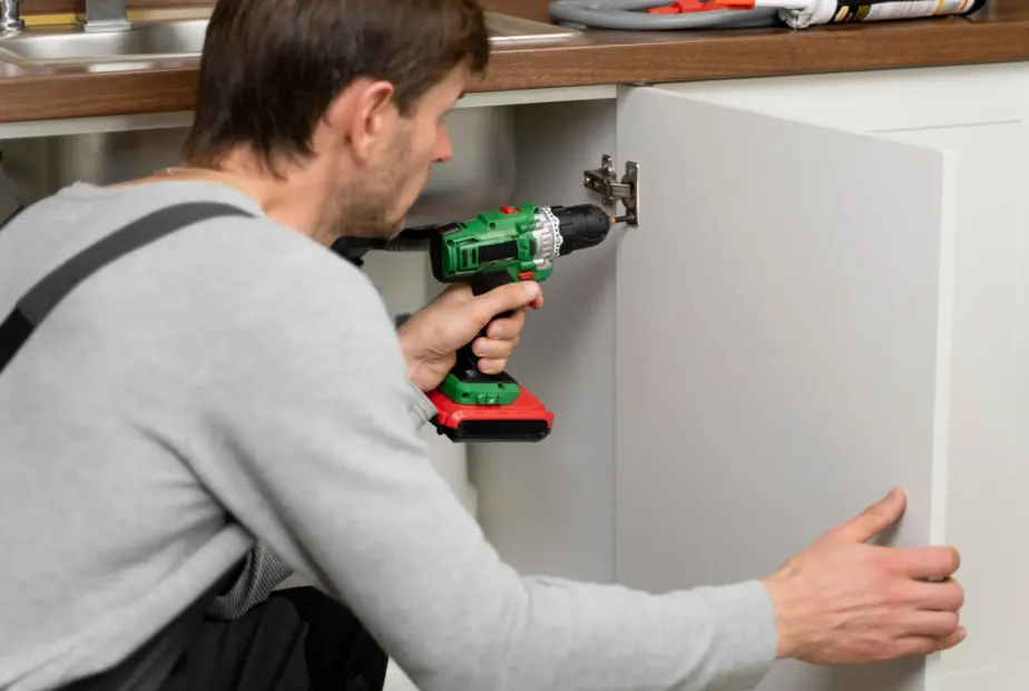 Melbourne homeowner reviewing custom kitchen cabinet drawings and material samples with a cabinet maker